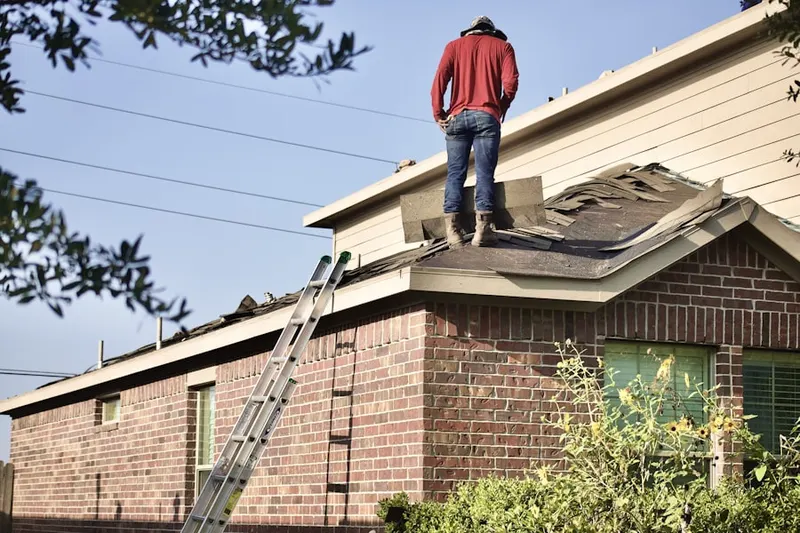 Professional roofer working on a residential roof in Leavenworth